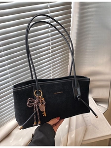 Chic black matte suede tote bag with golden lettering and stylish keychain pendant