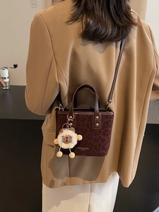 Vintage leopard print mini bucket bag with plush sheep charm and crossbody strap