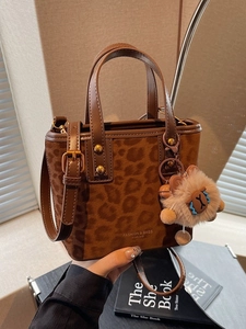 Chic leopard print bucket bag with dual handles and adjustable strap for women