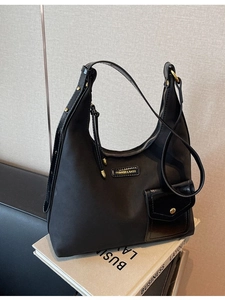 Fashionable black nylon tote bag with polished trim and gold hardware for daily commuting