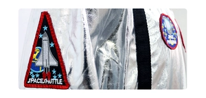 Detail of silver astronaut costume with embroidered Space Shuttle and Space Program patches