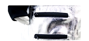 Detailed macro view of silver metallic space suit with black zippers and elastic cuffs