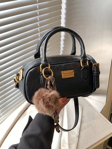 Premium black vintage boston bag with gold hardware and plush charm for women