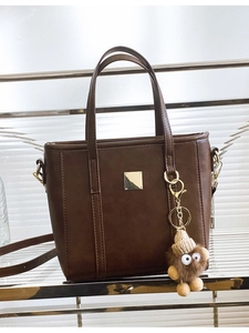 Dark brown matte PU tote bag with gold metal plaque and cute plush doll pendant