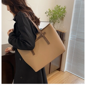 Detail of khaki pebbled leather tote bag showing large capacity for office commute