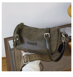 Detail view of olive green pillow bag with vintage texture and C&HEKA brand metal logo