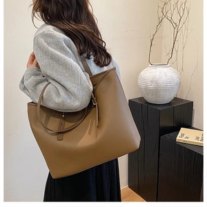 Detailed shot of brown tote bag featuring premium pebble grain texture and spacious design