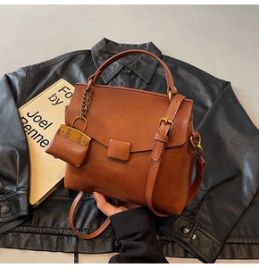 Detail of caramel brown retro PU leather crossbody bag with square buckle and mini pouch