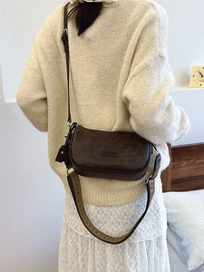 Retro dark brown crossbody pillow bag with wide strap and pebble grain leather texture