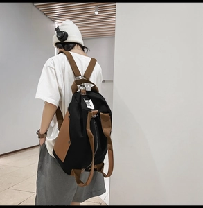 Close-up of dual-tone canvas backpack with street seven embroidery and side pocket