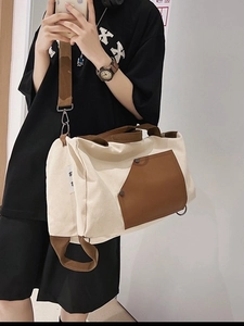 Versatile canvas tote bag in beige and brown shown on model for a casual styling