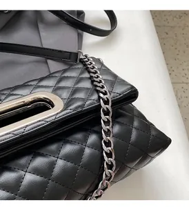 Detailansicht der schwarzen Stepptasche mit silberner Kette und ovalem Metallschnalle