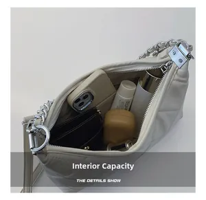 Internal capacity of quilted cream shoulder bag with silver chain and essentials