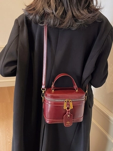 Elegant burgundy leather box vanity bag with gold zipper and stylish handle for women