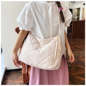 Quilted light pink tote bag shown from a 45-degree angle for size and capacity detail