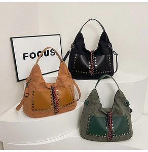 Close-up of suede hobo bags with metal studs and double front pockets in three colors