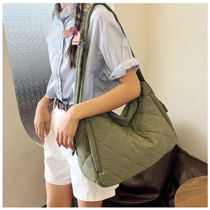 Olive green quilted nylon tote bag with adjustable wide shoulder strap and crossbody style