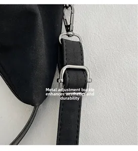 Detail of adjustable shoulder strap with durable silver metal buckle on black bucket bag