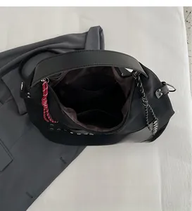 Macro detail of spacious inner compartment with zip pocket and stylish rivet base