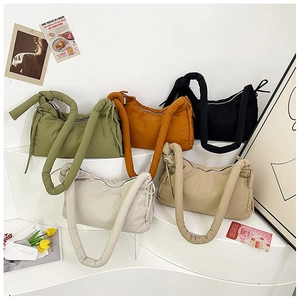 Detailed arrangement of padded nylon bags in various colors with knotted shoulder straps