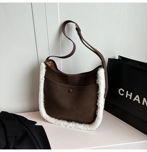 Detail of suede crossbody bag with fuzzy shearling trim and magnetic snap closure