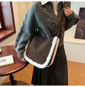 Detail of vintage lamb wool messenger bag with brown suede and white fur trim on model