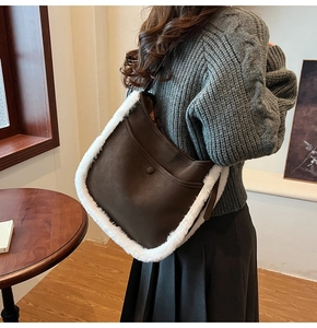 Detail of vintage brown shoulder bag with white fleece trim and magnetic pocket