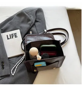 Interior view of brown faux leather backpack showing large storage capacity for daily items