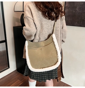 Detail of green suede bucket bag with white faux fur trim and decorative metal buckle