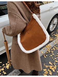 Frosted suede bucket bag in camel with white plush trim and long leather strap for fall