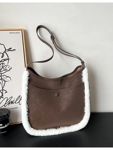 Deep brown matte suede bucket bag with white faux fur trim and adjustable strap