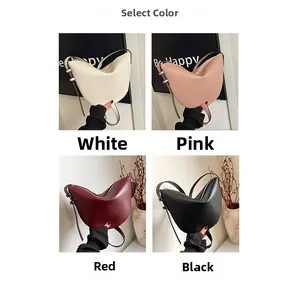 Close-up of crescent bucket bags in white, pink, red, and black with adjustable straps