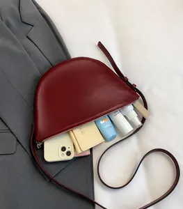 Detail showing the large interior capacity of this burgundy leather crescent bucket bag