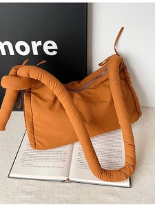 Quilted nylon crossbody bag in bright orange with puffy knotted shoulder straps