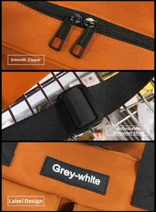 Detail of orange canvas tote with smooth zipper, adjustable strap, and brand label