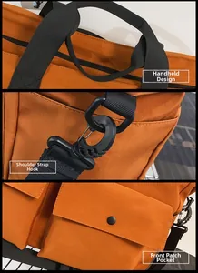 Detail of orange canvas tote with reinforced black handles and adjustable strap hooks