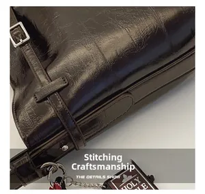 Close-up of premium stitching craft and silver buckle on dark brown glossy leather bag