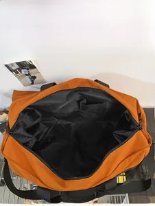 Interior view of orange canvas tote showing large capacity and internal pockets