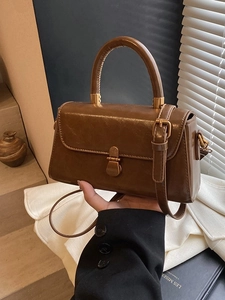 Vintage brown leather square handbag with golden clasp and adjustable shoulder strap