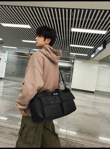 Detailed view of black nylon tote bag with utility pockets for daily commute and travel
