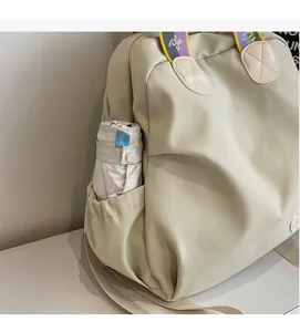 Detail of durable nylon backpack side pocket storing a purple folding sun umbrella