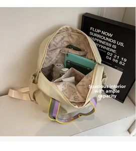 Spacious interior of beige nylon backpack with organized compartments for electronics