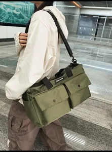 Detailed view of large army green waterproof nylon travel tote bag with flap pockets