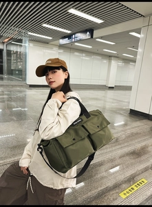Olive green utility tote bag with large front flap pockets for city commute