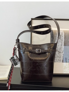 Retro dark coffee glossy bucket bag with adjustable strap and decorative pendant detail