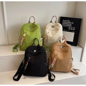 Detail of four colorful backpacks featuring vibrant geometric pattern straps and top handles