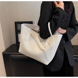Detailed view of white woven texture on a large minimalist tote bag for women