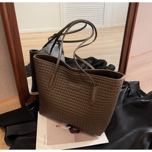 Detail of dark brown woven tote bag showing the Intrecciato leather texture on satin cloth