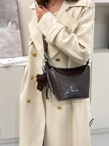 Retro coffee bucket bag with wax leather texture, bear charm, and white logo print