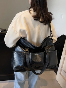 Fashionable black large capacity tote bag with glossy pleated texture and shoulder strap